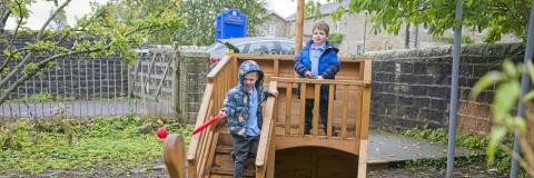 On the wooden boat on the playground